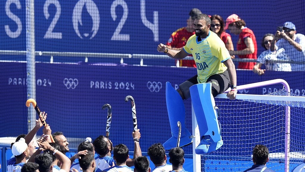 AP : PR Sreejesh (in yellow jersey) sits on the goal cross-bars as India's players celebrate after winning the bronze medal match against Spain at the Paris Olympics.