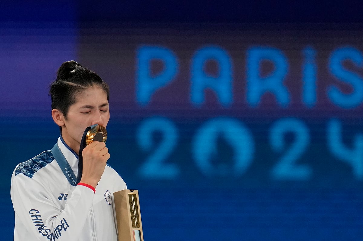 (AP Photo/Ariana Cubillos) : Gold medalist Taiwan's Lin Yu-ting poses during a medals ceremony for the women's 57 kg final boxing match at the 2024 Summer Olympics, Saturday, Aug. 10, 2024, in Paris, France. 