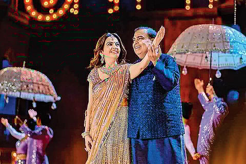 Mukesh Ambani with wife Nita Ambani performing at the function