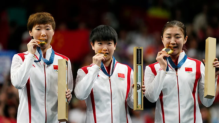 China athletes with the gold medals pose during the medal ceremony of the women's team table tennis match at the 2024 Summer Olympics. - AP Photo/Petros Giannakouris