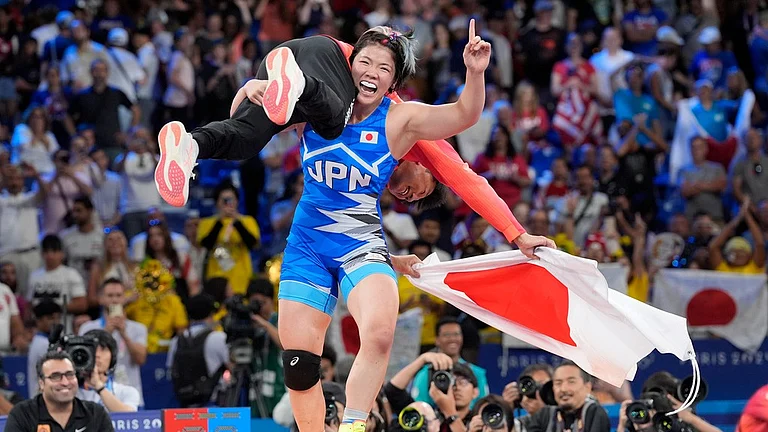Japan's Yuka Kagami celebrates after defeating Kennedy Alexis Blades, of the United States, in their women's freestyle 76kg final wrestling match. - AP/Eugene Hoshiko