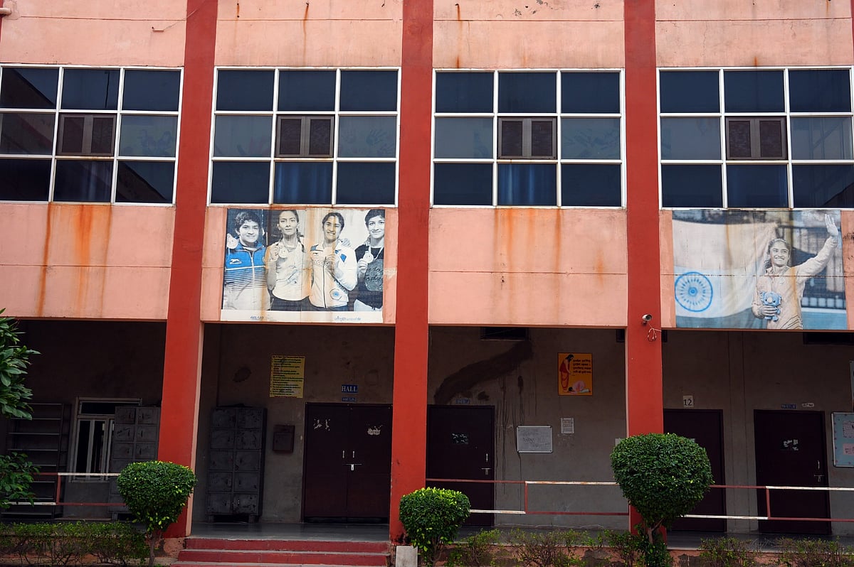 A picture of the Phogat sisters on the wall at Mahavir Phogat VMPS in Jhojhu Kalan, Haryana