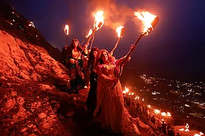 Iraqi Kurdish people carry fire torches, as they celebrate Nowruz