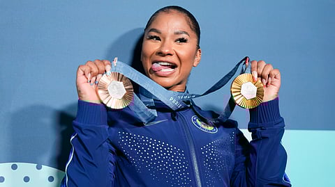 Jordan Chiles, of the United States, holds up her medals after the women's artistic gymnastics individual apparatus finals Bercy Arena at the 2024 Summer Olympics, Monday, Aug. 5, 2024, in Paris, France.