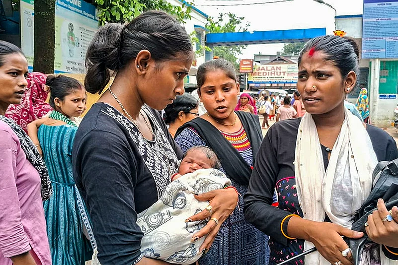Woman with newborn child outside district hospital during Doctors strike at Siliguri, in Darjeeling