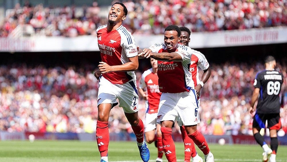 Photo: Adam Davy/PA via AP : Arsenal players celebrate a goal during a club friendly.