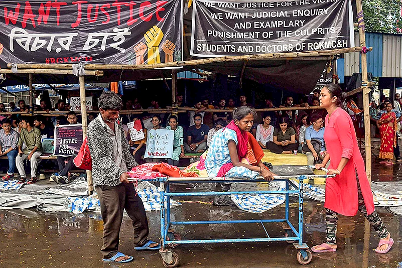 Relatives assist a patient as Doctors strike at R G Kar Hospital in Kolkata