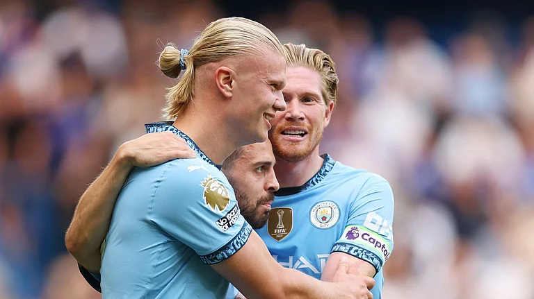 Erling Haaland (left) helped Manchester City get off to a winning start on Sunday. - null