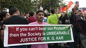 PTI : A protester holds a placard against the alleged rape and murder of a postgraduate trainee doctor, near Salt Lake stadium in Kolkata on Sunday (August 18, 2024).