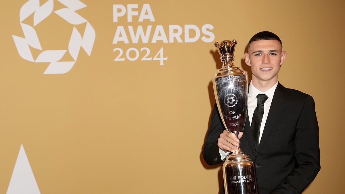 Phil Foden poses with the PFA Players' Player of the Year trophy