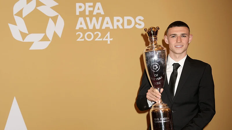 Phil Foden poses with the PFA Players Player of the Year trophy