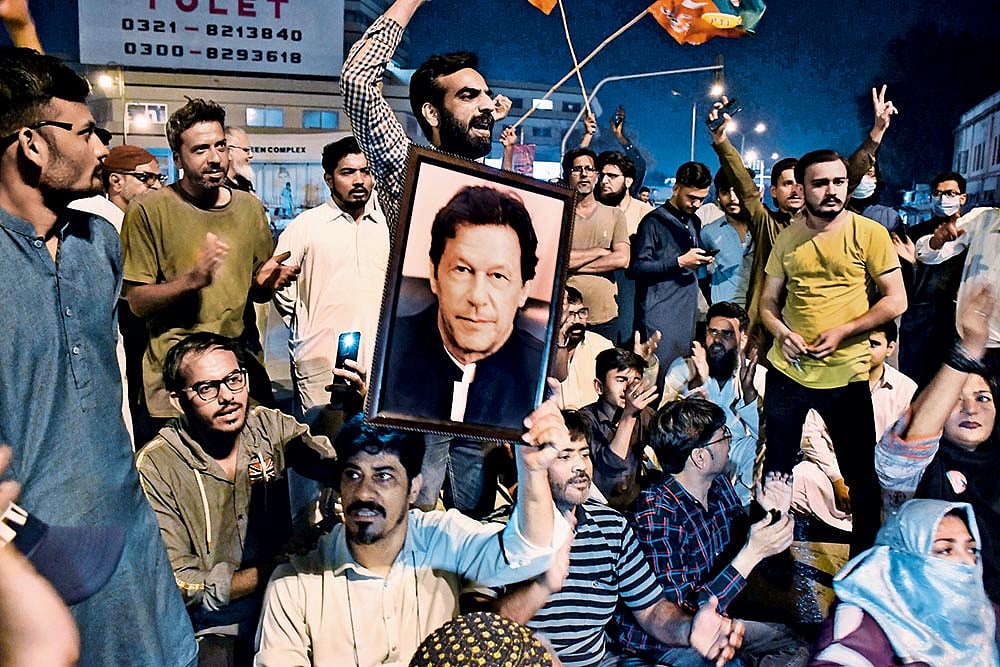 Photo: Getty Images : Standing By: Supporters of Imran Khan’s Tehreek-e-Insaf stage a protest after his arrest