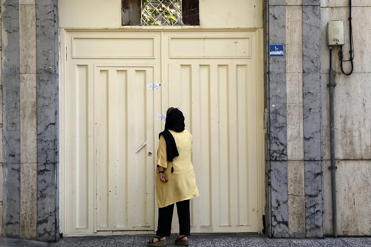 A woman reads the closure notice on German teaching institute in Tehran |