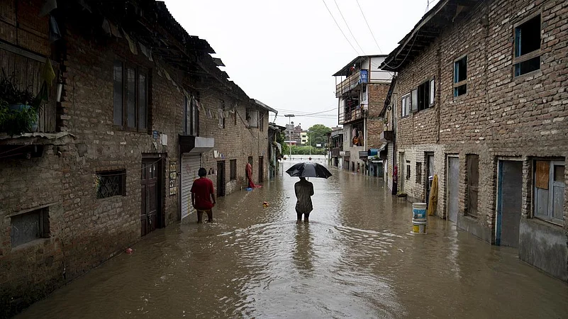 A man walking through a flooded lane near Bagmati River in Kathmandu
