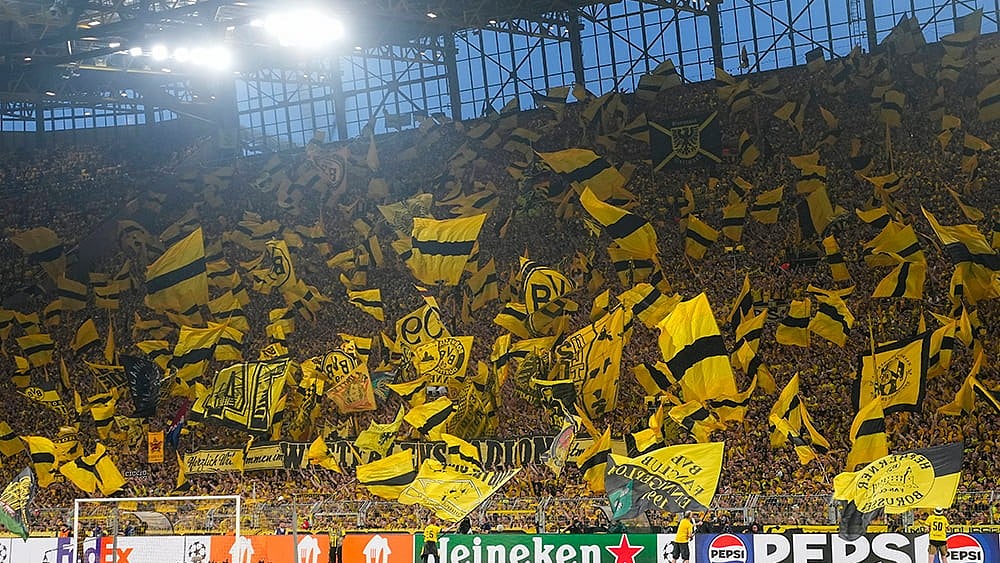 | Photo: AP/Martin Meissner : Borussia Dortmund fans with flags during Champions League semifinal against PSG.