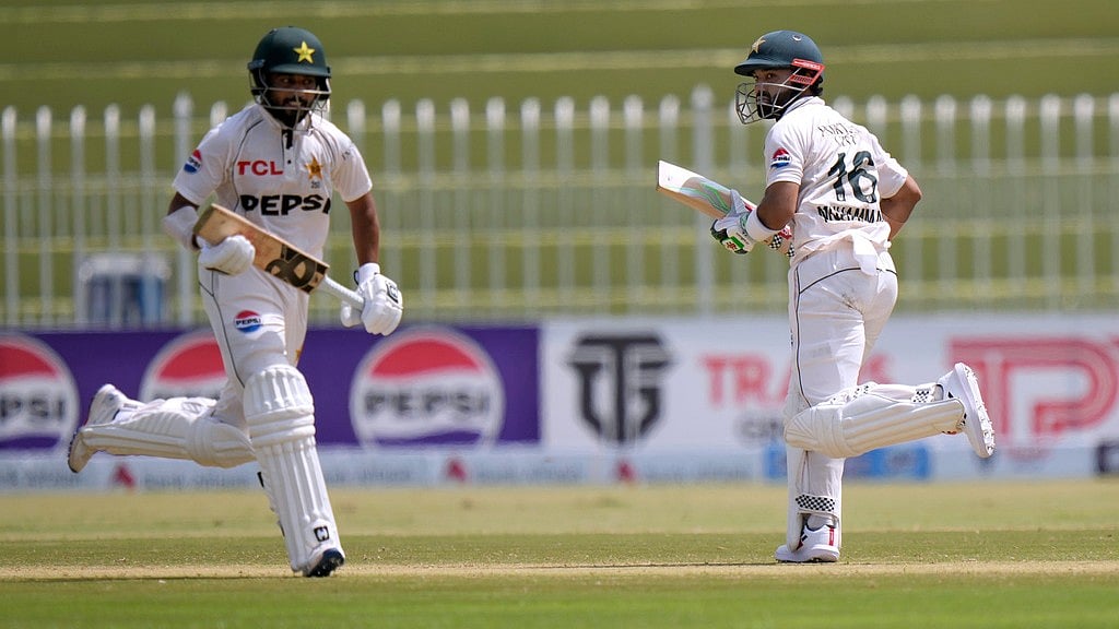 AP/Anjum Naveed : Pakistan's Mohammad Rizwan, right, and Saud Shakeel run between the wickets during the second day of first cricket Test.