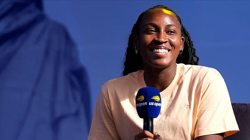 Coco Gauff smiles while speaking to the crowd at the US Open. AP Photo