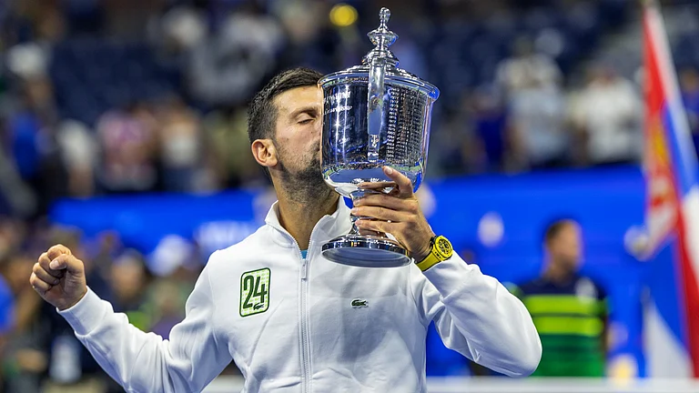 Novak Djokovic celebrates with the trophy in 2024 - null