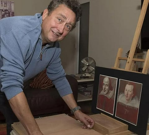 Steven Wadlow with William Shakespeare's portraits.