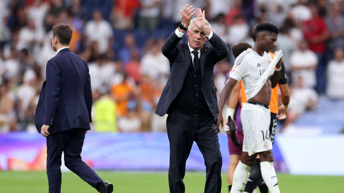 Carlo Ancelotti applauds Madrid's fans.