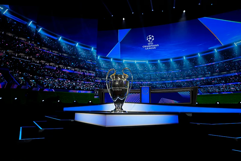 Champions League trophy is displayed.