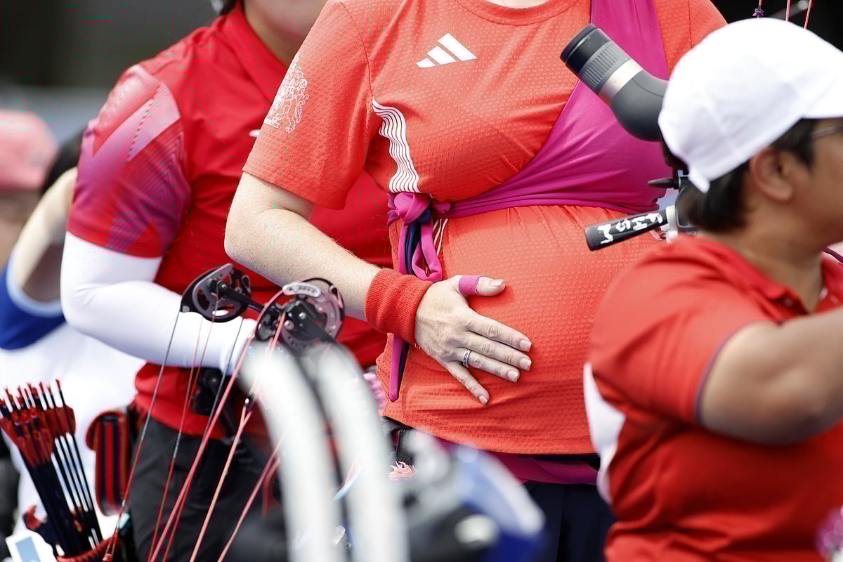(AP Photo/Felix Scheyer) : Archer Jodie Grinham touches her tummy during the Paralympic Games in Paris, on Thursday, Aug. 29, 2024. Grinham is 28 week into her pregnancy. The British Paralympian is competing in the ST classification. 