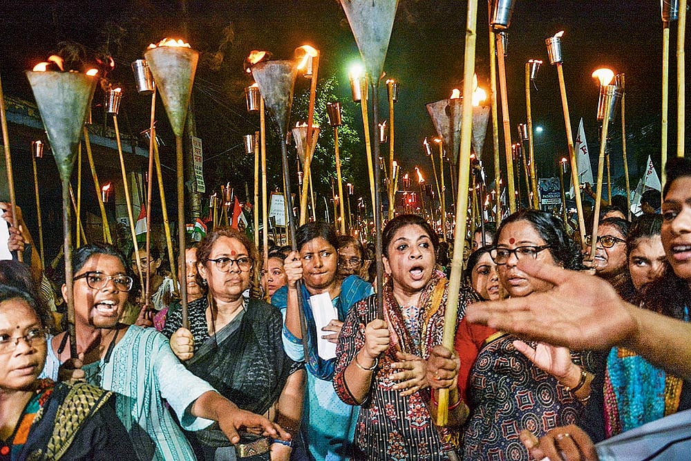 Photo: PTI : Holding A Vigil: People take part in a torch rally in Kolkata on August 14, 2024
