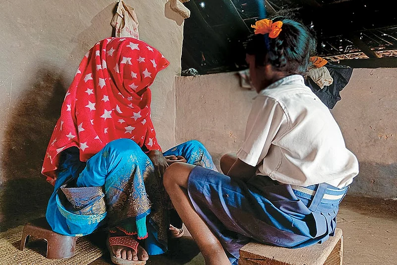 The nine-year-old survivor with her mother at their residence
