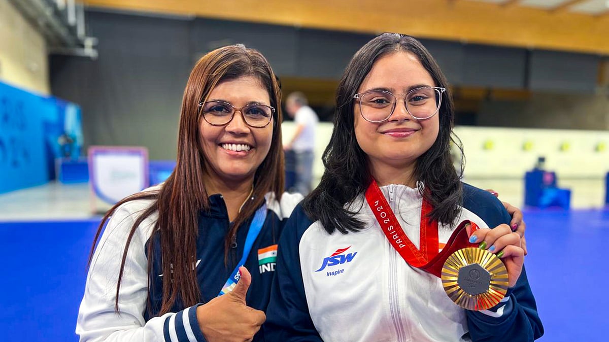 India's Avani Lekhara with her coach Suma Shirur poses for photos after winning the gold medal in the women's 10m air rifle (SH1) shooting event at the Paralympics 2024, in Paris, France, Friday, Aug. 30, 2024.

 - PTI