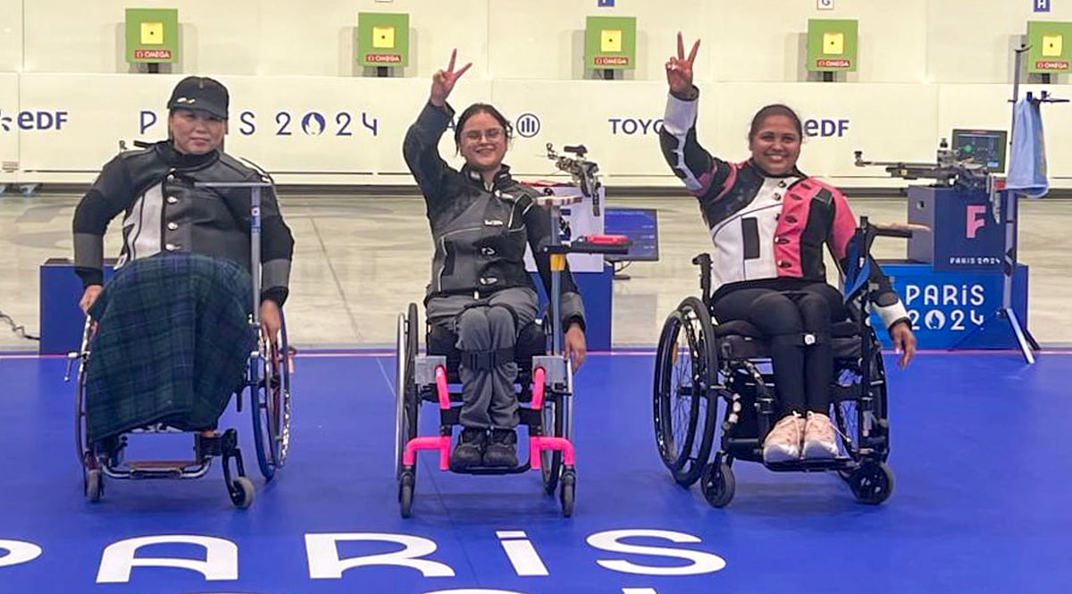 PTI Photo : India's Avani Lekhara, centre, and Mona Agarwal, right, pose for photos after winning the gold medal and bronze medal respectively in the women's 10m air rifle (SH1) event at Paralympics 2024, in Paris.