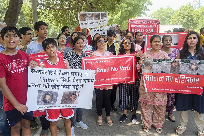 People protest against the government over bad condition of roads, in Gurugram