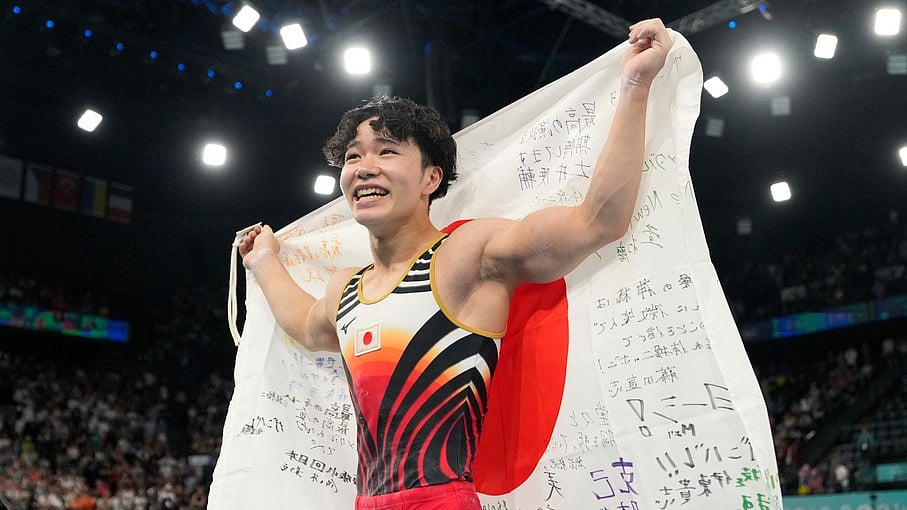 AP : Shinnosuke Oka, of Japan, celebrates after winning the gold medal during the men's artistic gymnastics all-around finals in Bercy Arena at the 2024 Summer Olympics, Wednesday, July 31, 2024, in Paris, France.