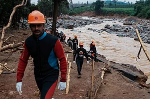 AP : Rescuers make their way to the upper regions as they search through mud and debris for a third day after landslides in Wayanad