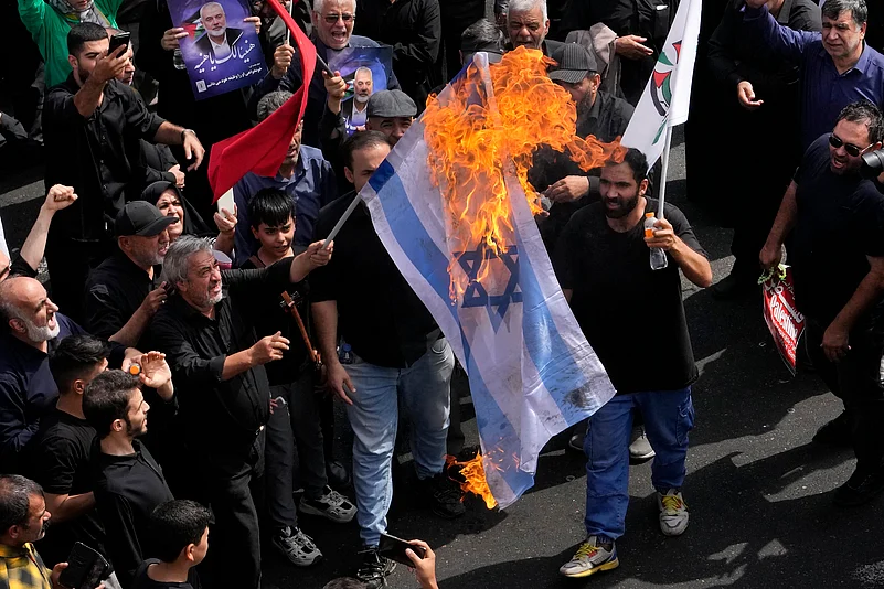 Iranians burn Israeli flag during the funeral Ismail Haniyeh