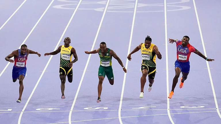 Noah Lyles, of the United States, Oblique Seville, of Jamaica,Akani Simbine, of South Africa, Kishane Thompson, of Jamaica, and Fred Kerley, of the United States, cross the finish line in the men's 100 meters final at the 2024 Summer Olympics - Martin Meissner/AP