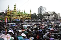 (Photo by Rupak De Chowdhuri/NurPhoto via Getty Images : Trinamool Congress (TMC) party supporters are holding umbrellas during heavy monsoon rain as they are attending a rally to commemorate the July 21, 1993 event where, according to Trinamool Congress (TMC) party leaders, 13 political party workers were killed by the police, in Kolkata, India, on July 21, 2024 