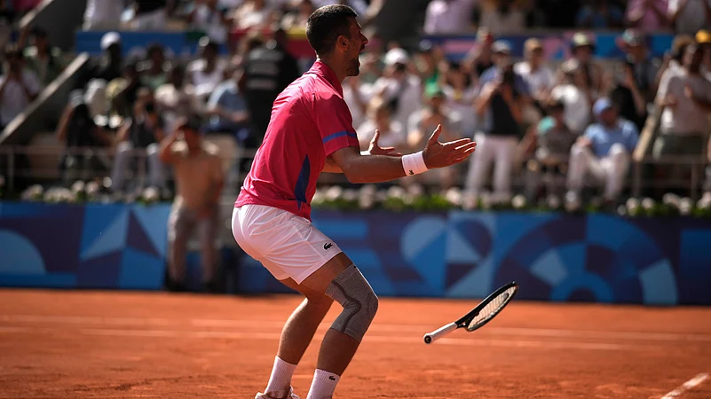 Novak Djokovic celebrates after winning the Olympic gold