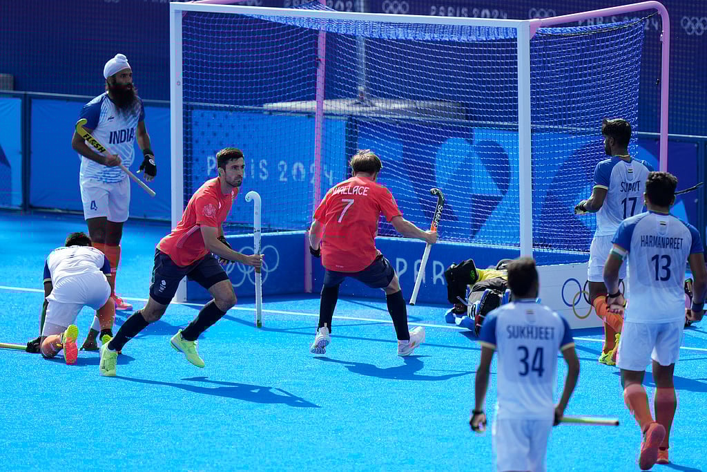 AP/Aijaz Rahi : Britain's Lee Morton, third left, celebrates after scoring his side's first goal during the men's quarterfinal field hockey match between Britain and India at the Yves-du-Manoir Stadium during the 2024 Summer Olympics, Sunday, Aug. 4, 2024, in Colombes, France.