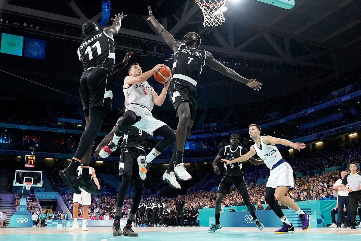  (AP Photo/Michael Conroy)
 : Serbia's Aleksa Avramovic (30) shoots as South Sudan's Marial Shayok (11), South Sudan's Wenyen Gabriel (9) and South Sudan's Bul Kuol (7) defend during a men's basketball game at the 2024 Summer Olympics, Saturday, Aug. 3, 2024, in Villeneuve-d'Ascq, France.

