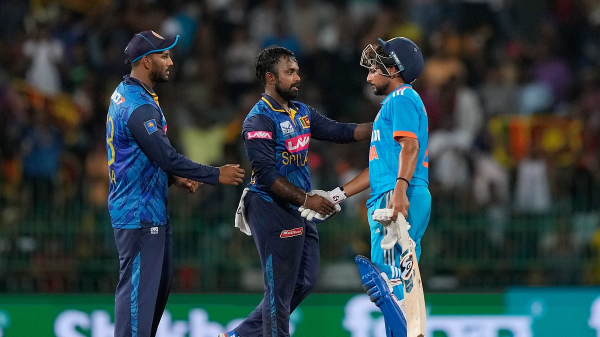 Sri Lanka's captain Charith Asalanka shakes hands with India's Kuldeep Yadav after the second ODI cricket match between Sri Lanka and India in Colombo. - AP Photo/Eranga Jayawardena