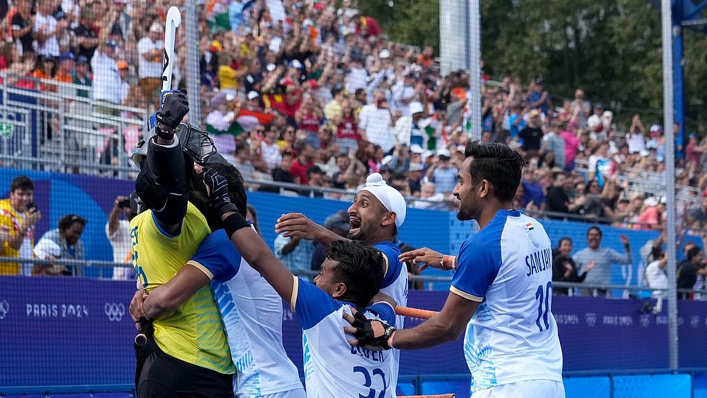 India's goalkeeper Parattu Reveendran Sreejesh, left, celebrates with teammates after winning the men's quarterfinal field hockey match between Britain and India at the Yves-du-Manoir Stadium during the 2024 Summer Olympics, Sunday, Aug. 4, 2024, in Colombes, France. - AP