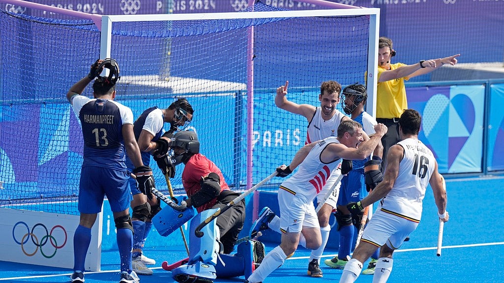 Belgium's John-John Dohmen, second right, celebrates after scoring his side's second goal during the men's Group B hockey match against India at the Yves-du-Manoir Stadium.  - Photo: AP/Aijaz Rahi