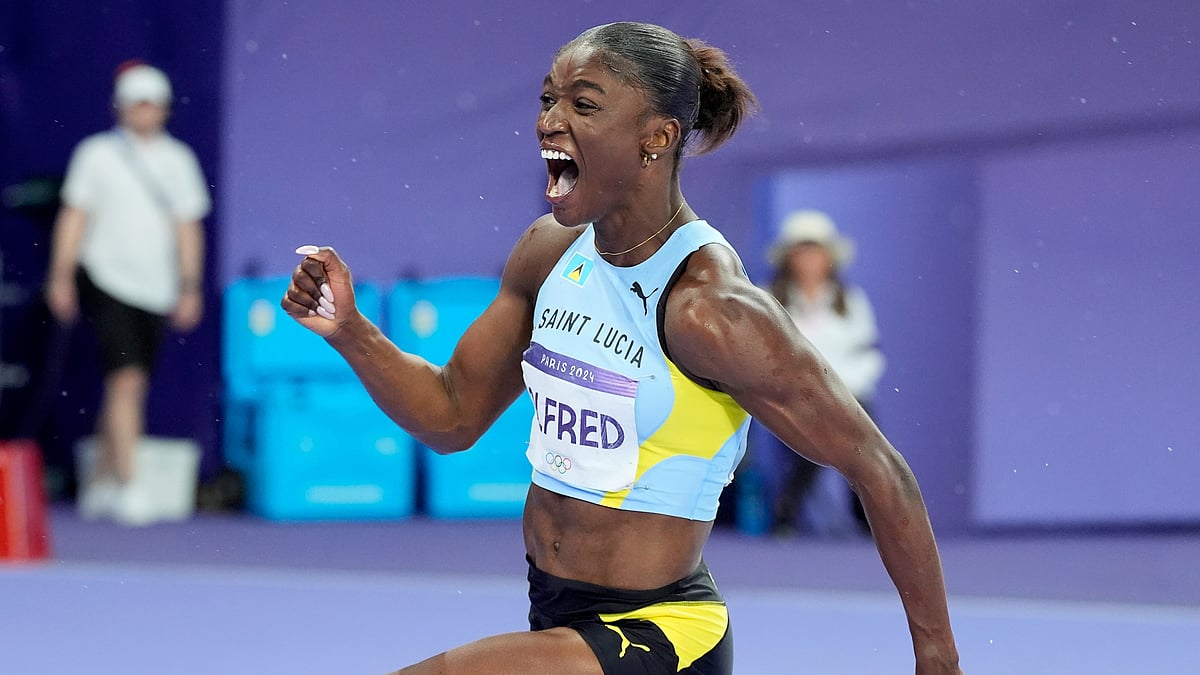 AP Photo/Matthias Schrader : Julien Alfred, of Saint Lucia, celebrates after winning the women's 100-meters final at the 2024 Summer Olympics, Saturday, Aug. 3, 2024, in Saint-Denis, France.
