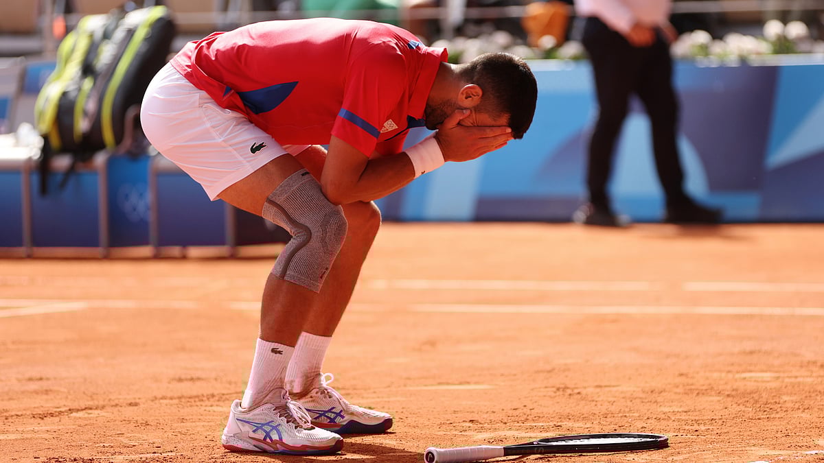 Novak Djokovic celebrates his mens singles gold medal at the Paris Olympics