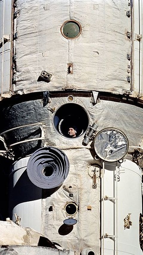 Valeri looking out of Mir's window |