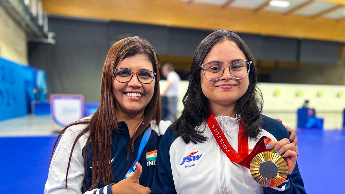 (PTI Photo) : Paris: India's Avani Lekhara with her coach Suma Shirur poses for photos after winning the gold medal in the women's 10m air rifle (SH1) shooting event at the Paralympics 2024, in Paris, France, Friday, Aug. 30, 2024. 