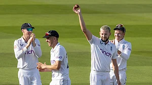 Gus Atkinson celebrates with the ball after another five-wicket haul at Lord's.