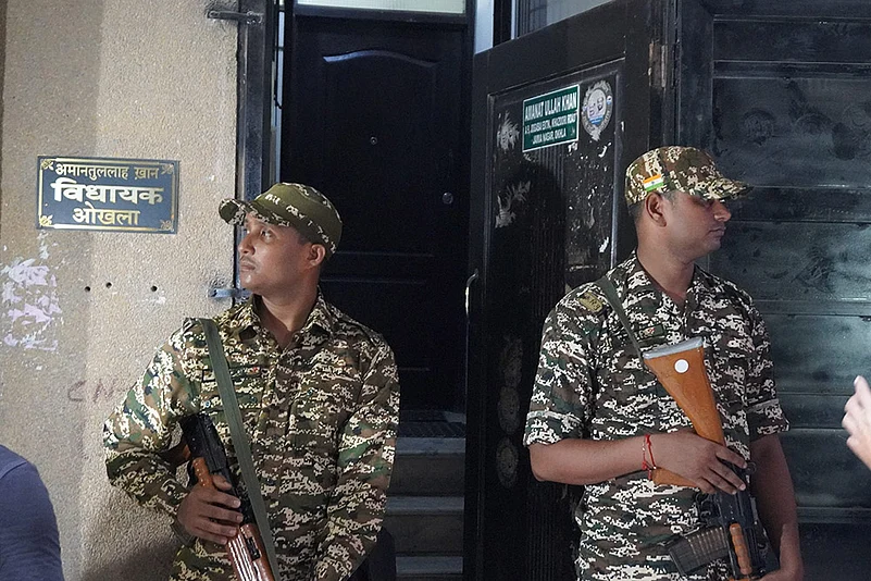 Security personnel stand guard as ED raids Amanatullah Khans premises