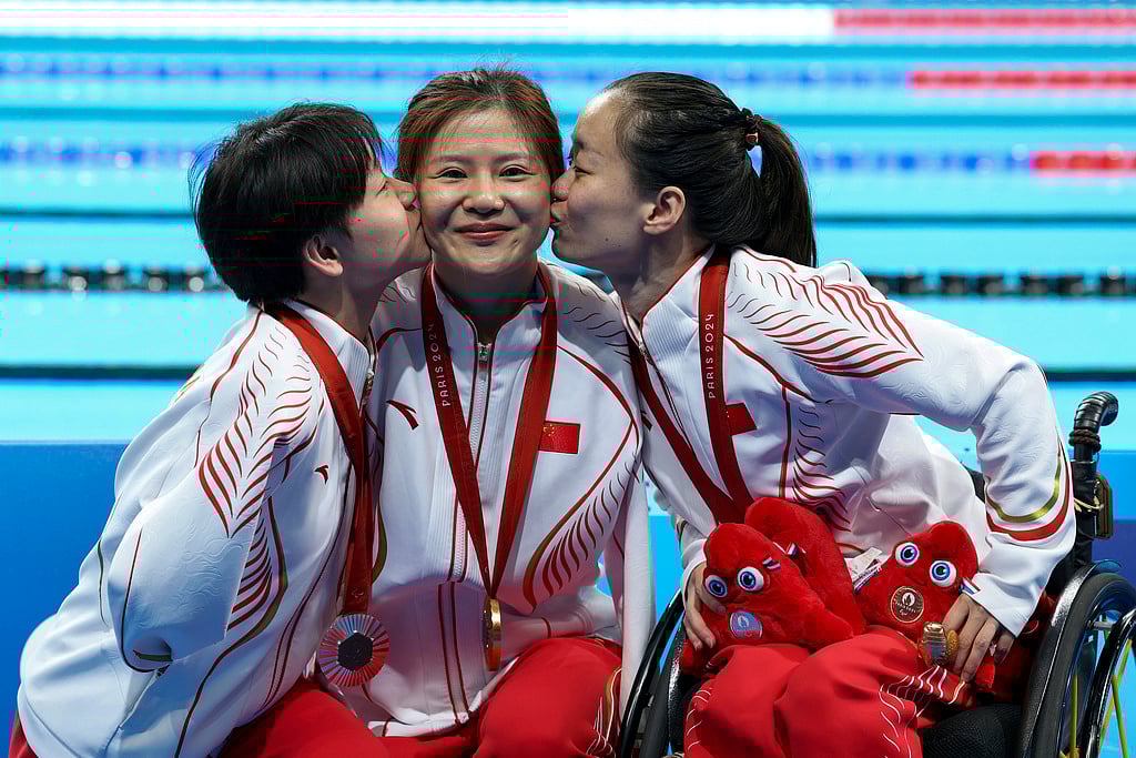 AP : Lu Dong, He Shenggao and Liu Yu, of China, celebrate their first, second and third position at the podium of Women's 50m Backstroke -S5 during the 2024 Paralympics, Tuesday, Sept. 3, 2024, in Paris, France.