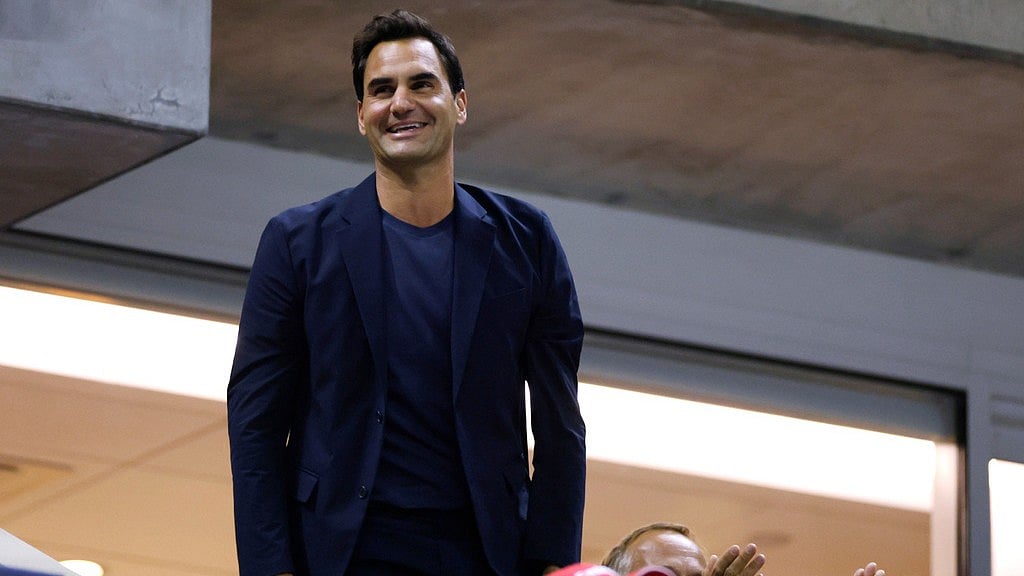 AP : Tennis great Roger Federer acknowledges the crowd during the quarterfinal match between Aryna Sabalenka, of Belarus, and Zheng Qinwen, of China, during the U.S. Open tennis championships.